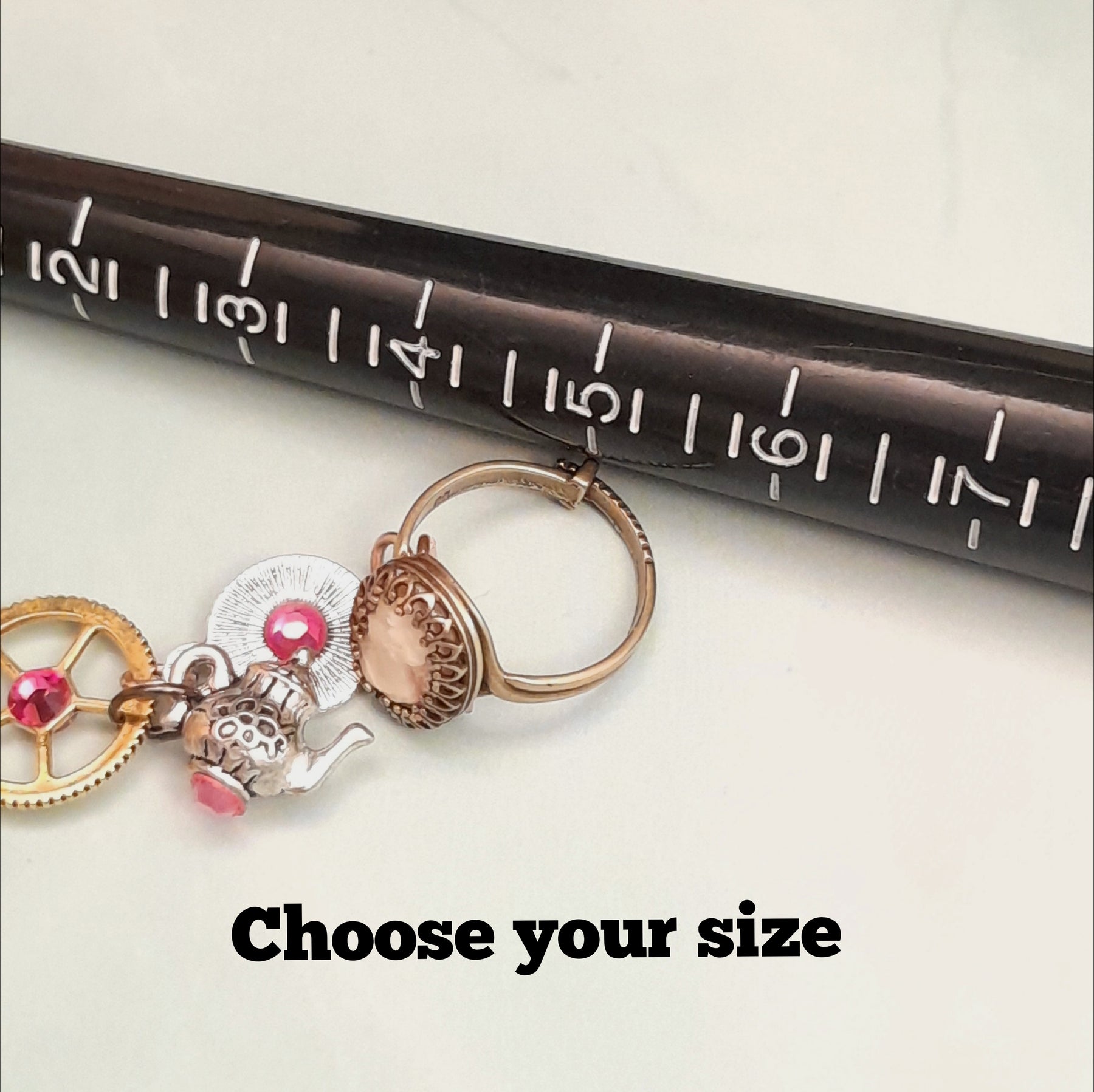 Rachel Flam Design Alice in Wonderland Hand-chain slave bracelet adjustable ring with ring sizer and teapot and gears. 