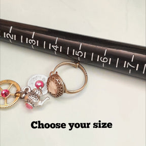 Rachel Flam Design Alice in Wonderland Hand-chain slave bracelet adjustable ring with ring sizer and teapot and gears. 