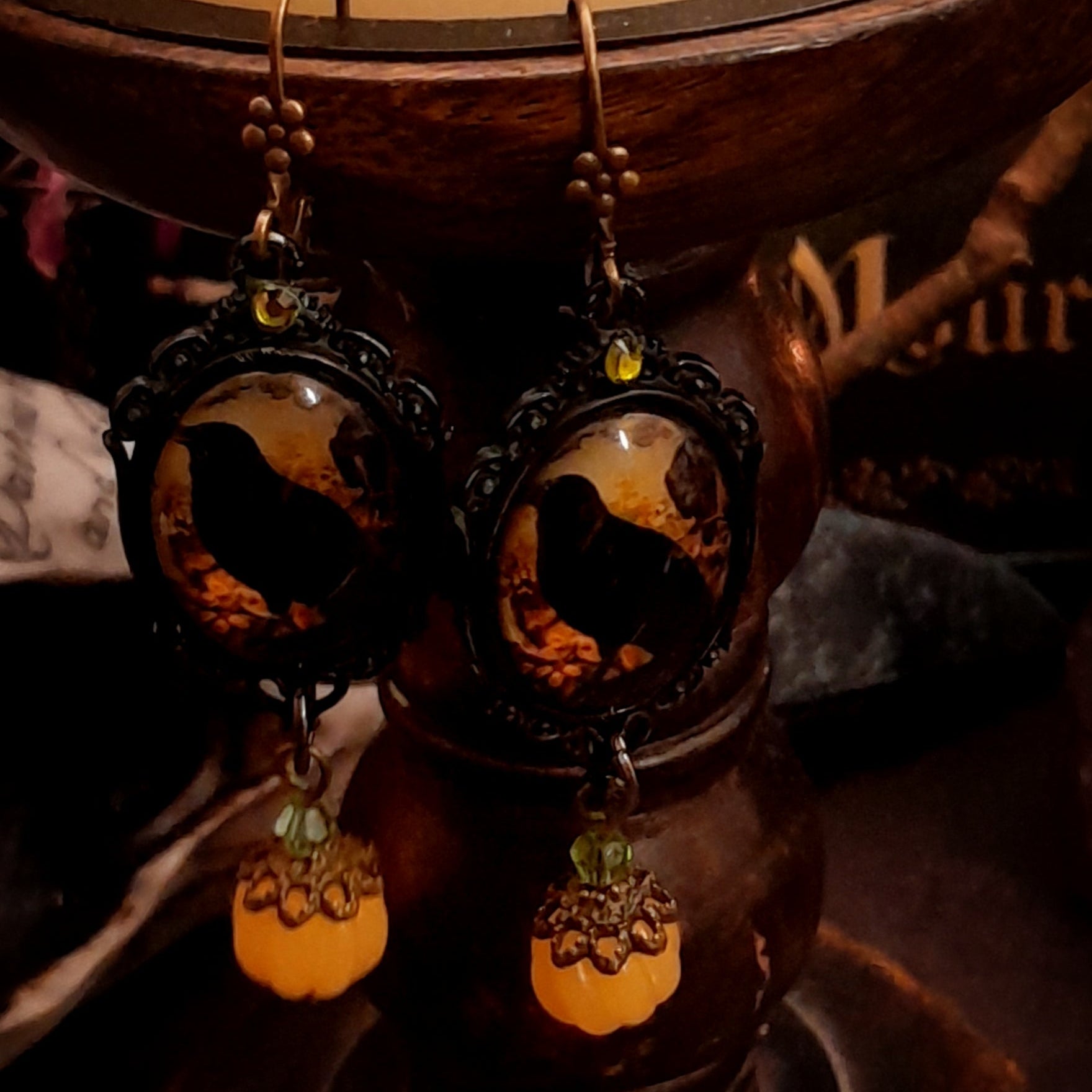 Elaborate handmade crow earrings with yellow pumpkins, crystal accents, framed woodland scenes, and autumn nature magic, Victorian style and vintage style fantasy jewelry by Rachel Flam Design
