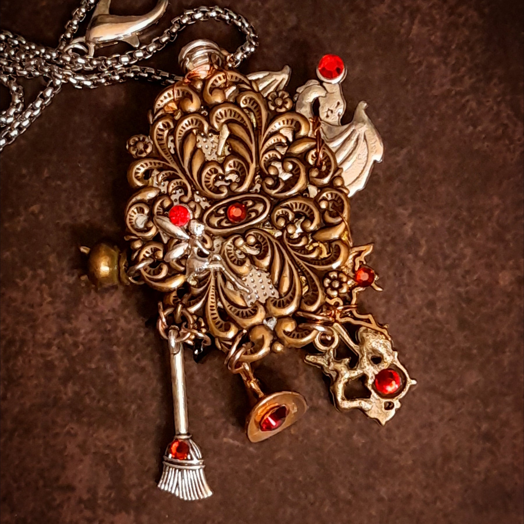 Back detail of handmade witchy black crow fairy and dragon necklace showing decorative filigree and sparkling Swarovski crystal, Victorian style vintage style magical fantasy jewelry