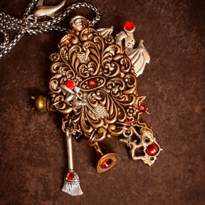 Back detail of handmade witchy black crow fairy and dragon necklace showing decorative filigree and sparkling Swarovski crystal, Victorian style vintage style magical fantasy jewelry