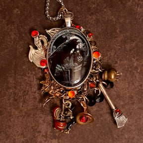 Close up of handmade witchy black crow fairy and dragon necklace with magical witch charms, crow centerpiece and Swarovski crystals, Victorian style vintage style magical fantasy jewelry
