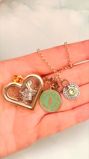 Rachel Flam Design Heart-Shaped Openable Locket Alice in Wonderland Magical Fantasy Charms Charms on hand for perspective and size Swarovski peridot crystals 