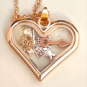 Magical Fantasy Alice in Wonderland heart-shaped locket necklace with white rabbit clock hand gear and gear close up. 