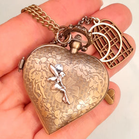Handmade magical fantasy heart pocket watch necklace back view with fairy charm, floral engraved antiqued brass, birdcage charm, Victorian style vintage style