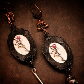 Halloween decorative backs of witch earrings with hidden fairy details, purple Swarovski crystals and ornate frames in Victorian style and vintage style by Rachel Flam Design