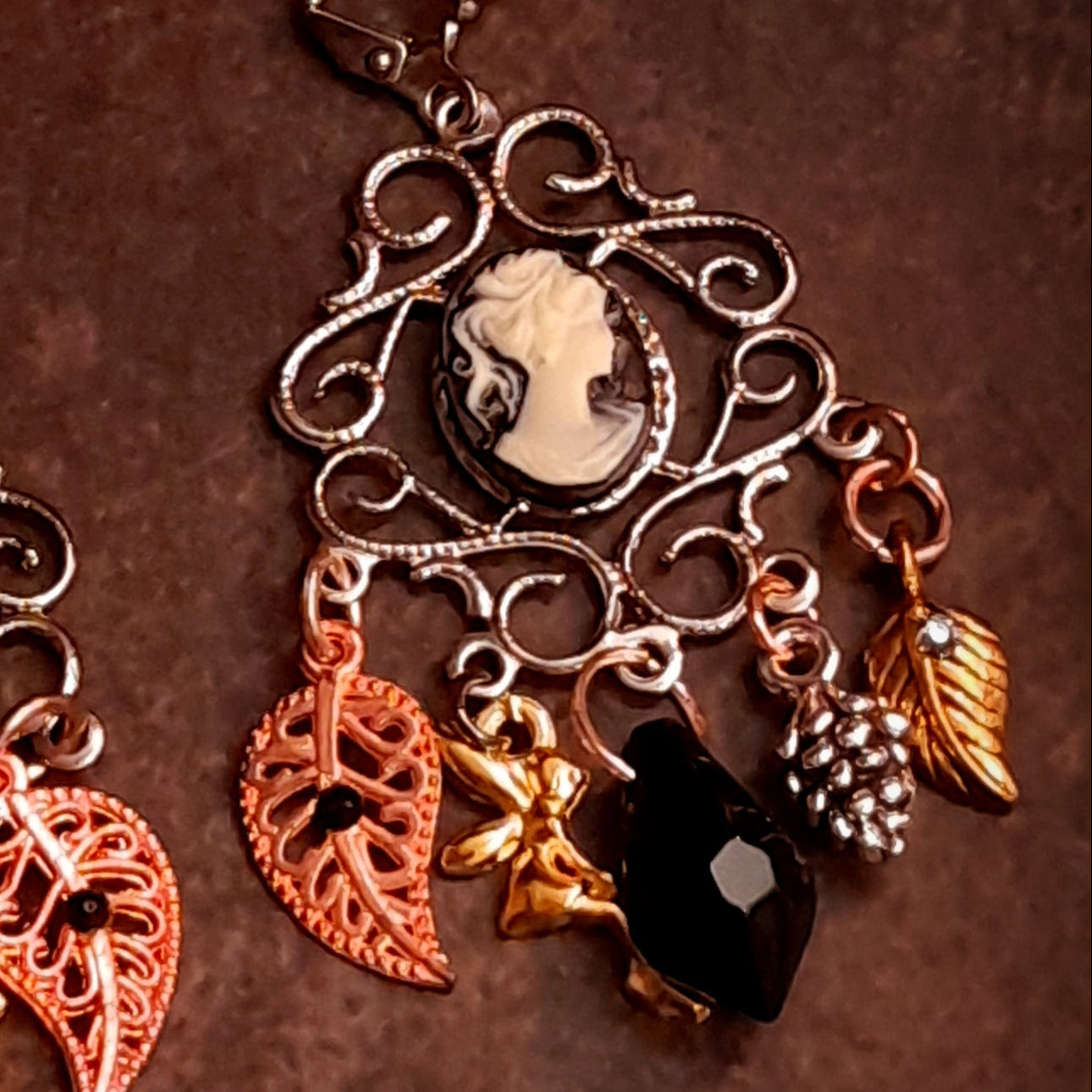 Jet black Swarovski crystal cameo earrings with romantic Victorian style scrollwork, elegant profile cameos, leaf charms, pinecones, and chandelier details, vintage style earrings by Rachel Flam Design