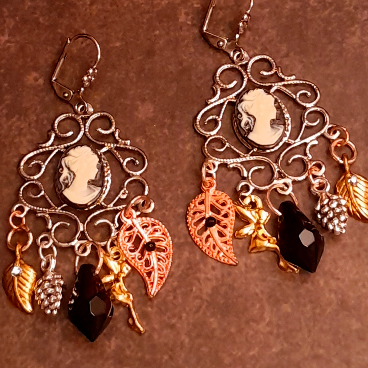 Romantic Victorian style chandelier earrings with old world cameo portraits, ornate scrollwork, jet black Swarovski crystals, leaves, pinecones, and nature inspired details, vintage style jewelry by Rachel Flam Design