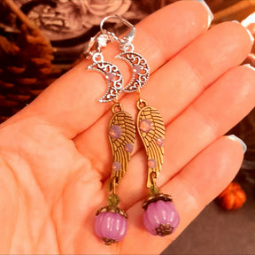 Magical fantasy celestial earrings with moon charms, crystal-accented angel wings, and lavender pumpkin drops, handmade vintage style Victorian style jewelry