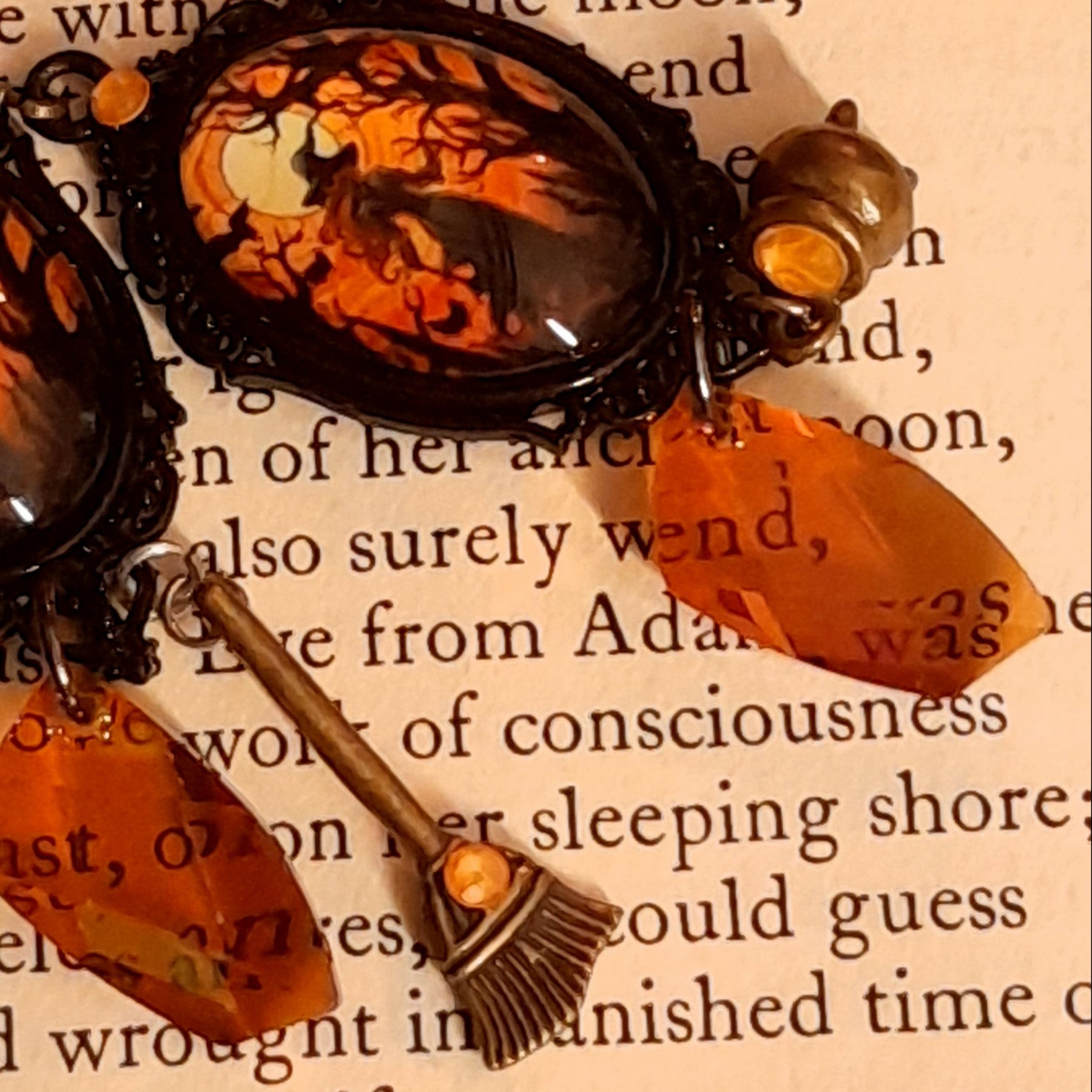 Elaborate Halloween witchy earrings with smoky Swarovski crystals, orange and black moonlit scenes, cauldron, broom, and hidden fairy charms, Victorian style and vintage style magical fantasy jewelry by Rachel Flam Design