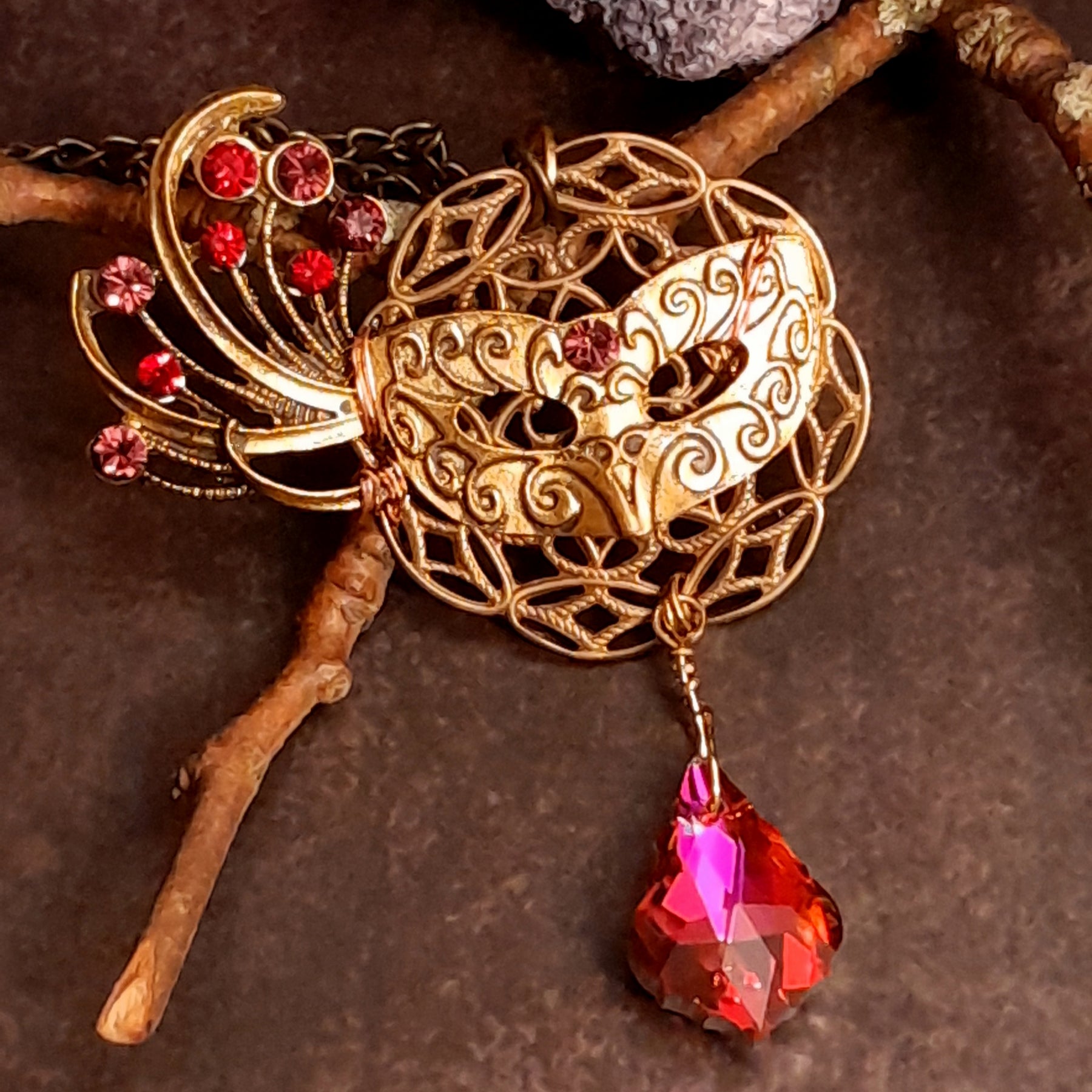 Victorian style vintage style masquerade mask necklace pendant with a red and pink Swarovski crystal feather fan and dangling crystal drop