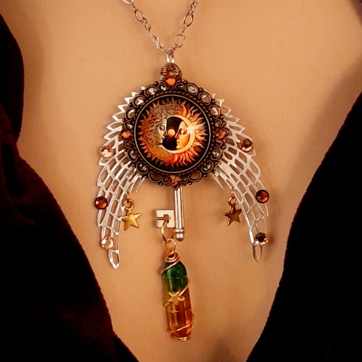 bohemian necklace with sun and moon cabochon, wings, stars, color changing crystal, and swarovski crystals 
