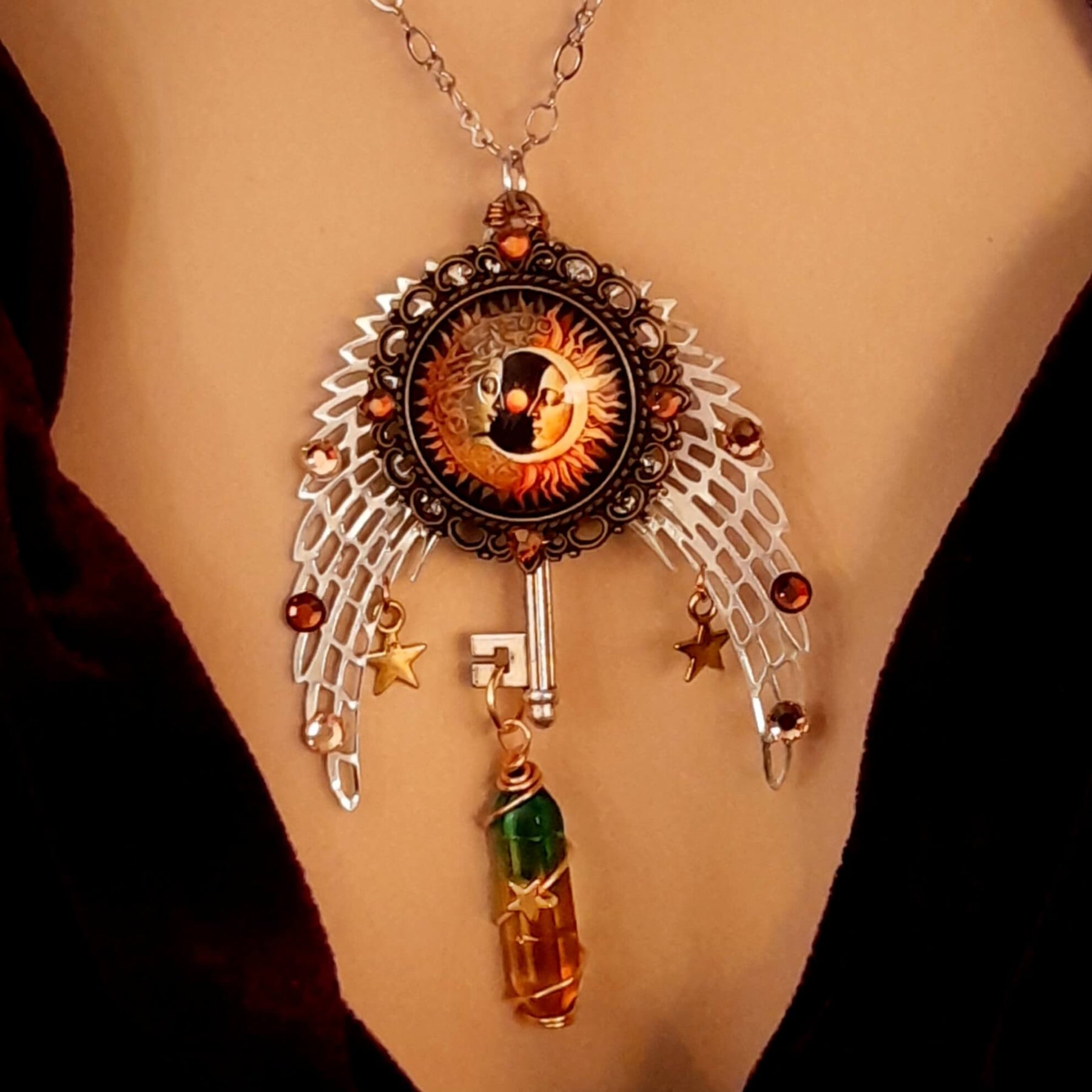 bohemian necklace with sun and moon cabochon, wings, stars, color changing crystal, and swarovski crystals 