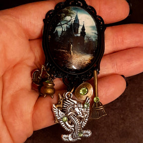 Victorian style vintage style fantasy necklace featuring a moonlit castle pendant, dragon charm, witch hat, cauldron, and Swarovski crystals, Rachel Flam Design