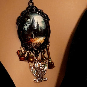 Victorian style vintage style fantasy jewelry necklace with mysterious castle pendant, dragon detail, broom charm, and Swarovski crystals, Rachel Flam Design