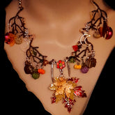 Handmade Halloween nature necklace with maple leaves, pumpkins, center flower, and Volcano Swarovski crystal moons, Victorian style vintage style magical fantasy jewelry by Rachel Flam Design