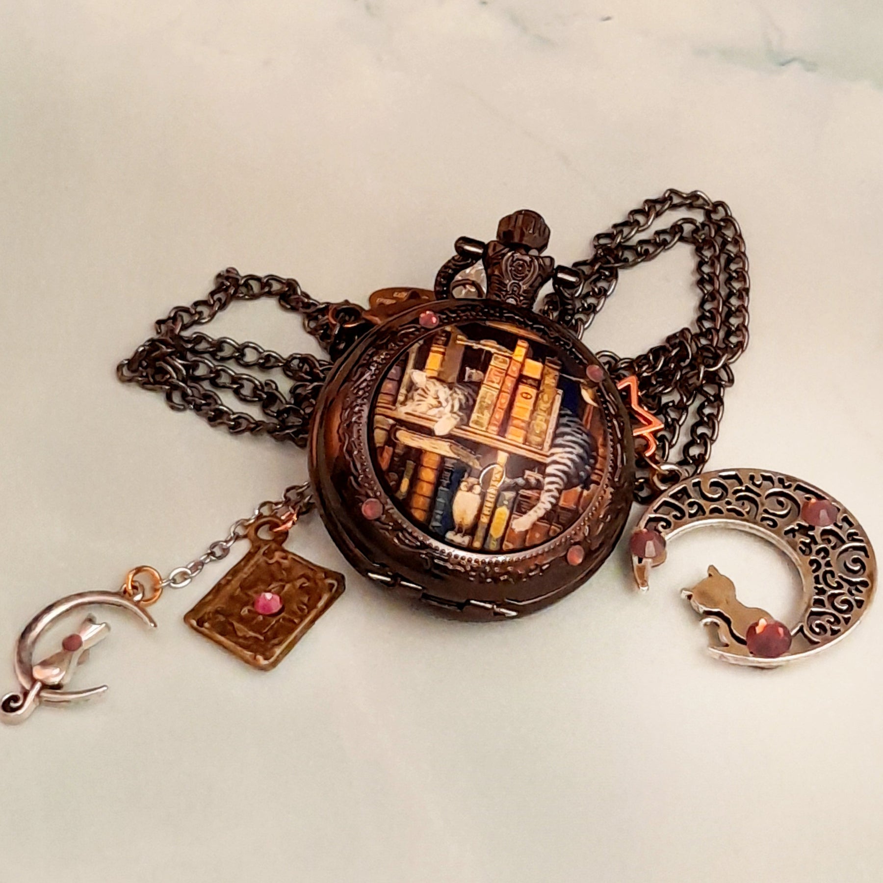 Handmade magical fantasy pocket watch necklace with sleeping cat and books scene Victorian style vintage style Swarovski purple crystals crescent moon cat charm and book charm antiqued brass