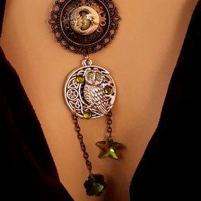 Moon sun cabochon necklace with a double sided owl and green swarovski crystals