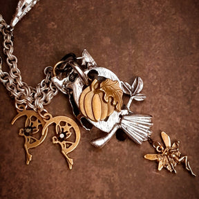 Back of handmade owl necklace showing pumpkin, broom and fairy charms, Victorian style and vintage style magical jewelry by Rachel Flam Design