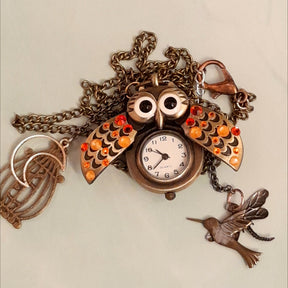 Cute owl pocket watch necklace wings open flat lay working clock face birdcage hummingbird dragonfly charms Swarovski orange crystals Victorian style vintage style handmade Rachel Flam Design