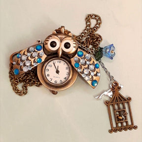 Cute owl pocket watch necklace wings open flat lay working clock face blue flower bird cage fairy charm Swarovski blue crystals Victorian style vintage style handmade Rachel Flam Design