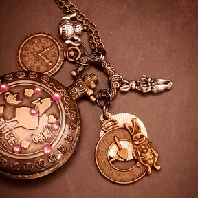 Detail view of magical handmade fantasy pocket watch necklace with Alice in Wonderland motif and world-renowned genuine Swarovski purple crystals