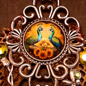 victorian style necklace with a peacock cabochon. Bright golden yellow and green crystals. Feather accents, a fairy, and a striking teardrop crystal