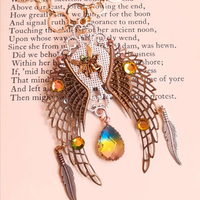 victorian style necklace with a peacock cabochon. Bright golden yellow and green crystals. Feather accents, a fairy, and a striking teardrop crystal
