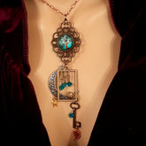 Victorian style bird necklace with tree of life cabochon, bird cage and bird, turquoise swarovski crystals silver filigree moon gold star and copper leaf. 