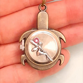 Back of turtle purse charm held in hand showing fairy with purple Swarovski crystal, lobster clasp clip, Victorian style vintage style handmade Rachel Flam Design
