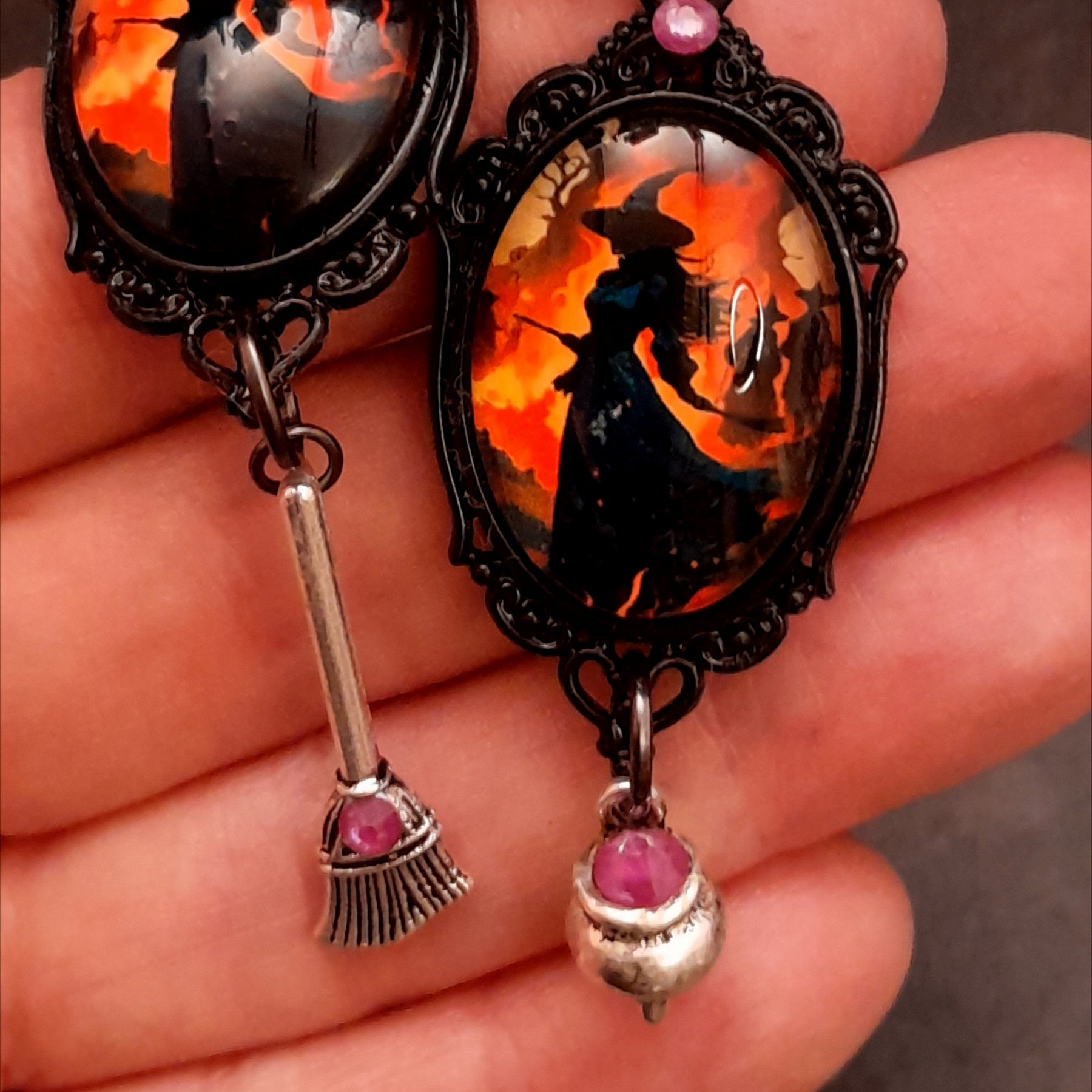 Halloween witch earrings with fiery orange scenes, broom and cauldron charms, and purple Swarovski crystals in Victorian style and vintage style by Rachel Flam Design