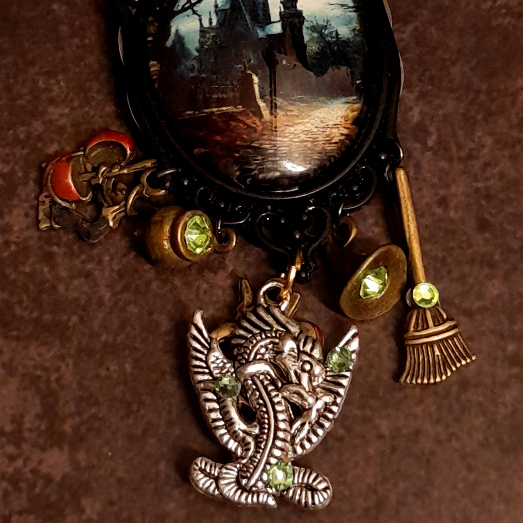Victorian style vintage style enchanted castle and dragon necklace with witch hat, cauldron, broom, magical charms, and glowing Swarovski crystals, Rachel Flam Design