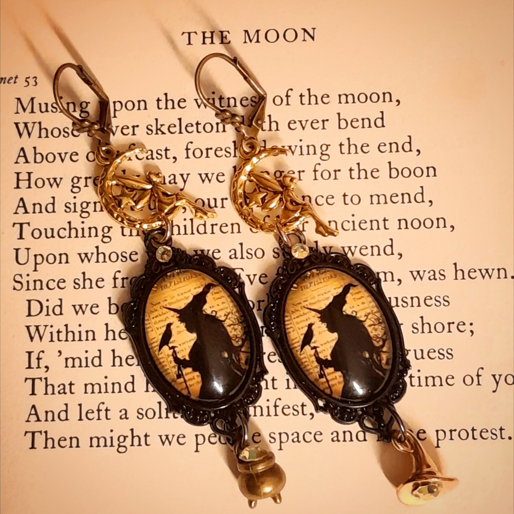 Halloween witch earrings featuring a dangling witch hat, miniature cauldron, fairy moon charms, raven imagery, and yellow Swarovski crystals, Victorian style vintage style magical fantasy jewelry