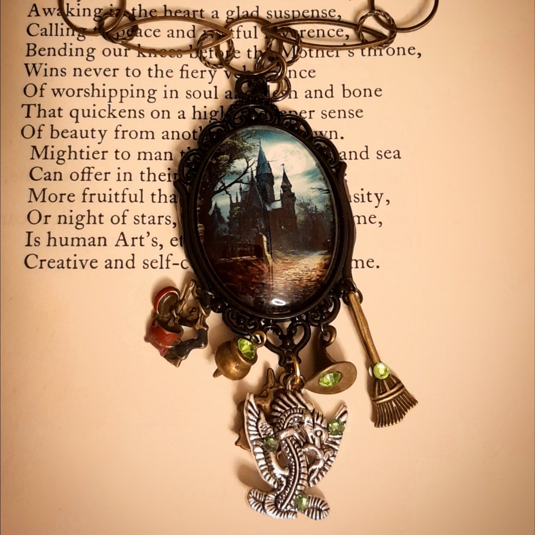 Victorian style vintage style witchy fantasy necklace with detailed castle scene, mystical charms, dragon pendant, and sparkling Swarovski crystals, Rachel Flam Design