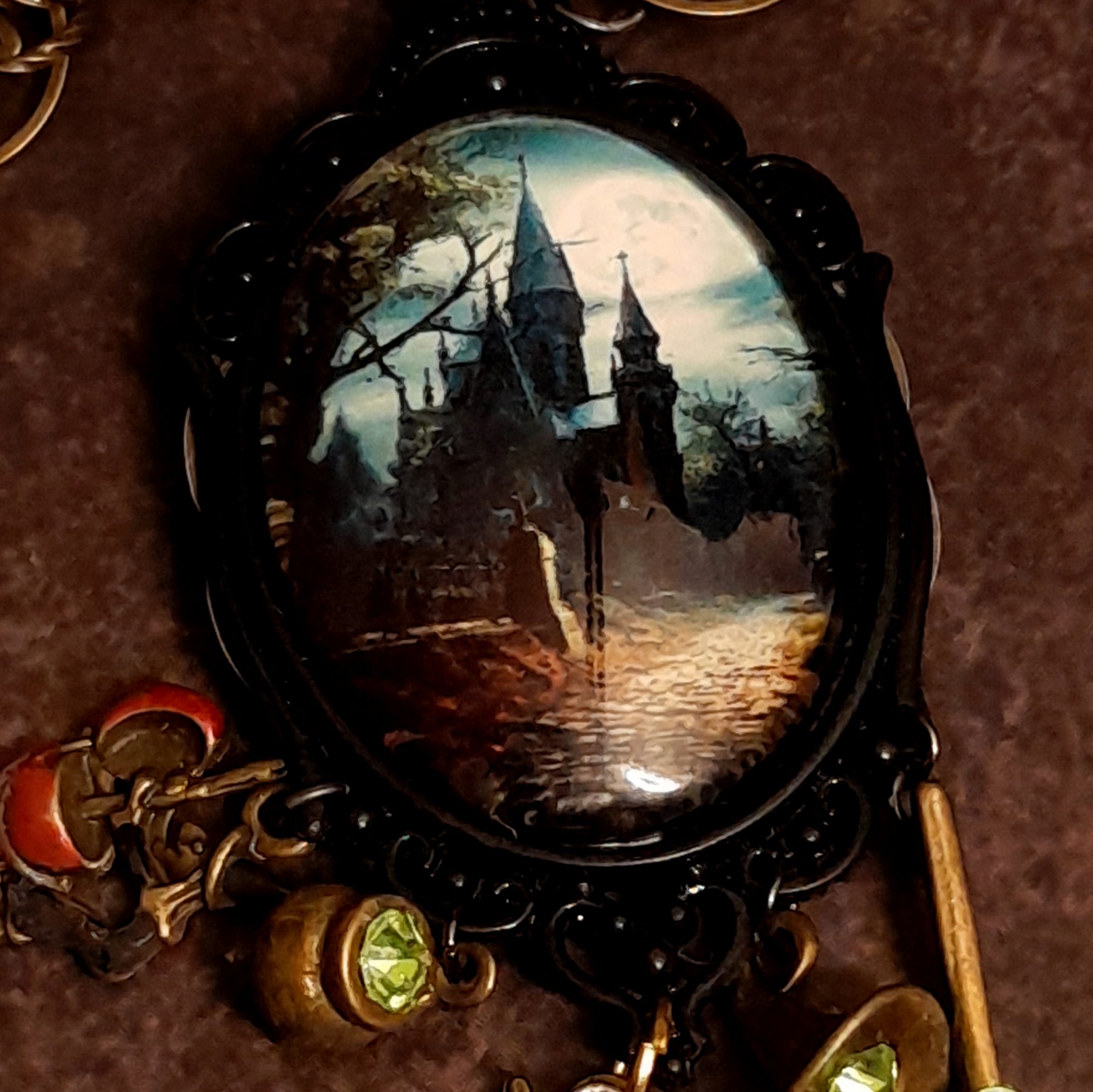 Victorian style vintage style witchy fantasy necklace with detailed castle scene, mystical charms, dragon pendant, and sparkling Swarovski crystals, Rachel Flam Design