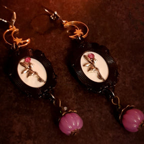 One-of-a-kind witchy crow earrings with crescent moons, stars, red and purple crystal accents, pumpkin charms, and secret fairy details on the backs, Victorian style and vintage style fantasy jewelry by Rachel Flam Design
