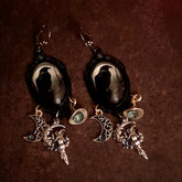 Handmade witchy crow earrings with a solitary raven beneath a pale moon, smoky Swarovski crystals, openwork crescent moon, witch hat, and celestial dangles, Victorian style and vintage style magical fantasy jewelry by Rachel Flam Design