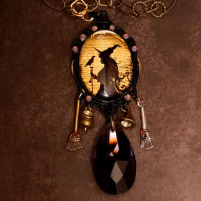 Handmade magical witchy necklace inspired by ravens and autumn magic, featuring a witch, broom, cauldron, and purple Swarovski crystals, Victorian style and vintage style fantasy jewelry by Rachel Flam Design