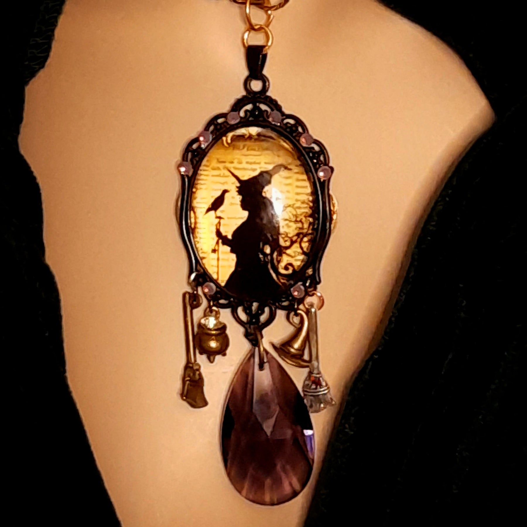 Handmade witchy crow necklace with a framed witch and raven scene, lavender purple Swarovski crystals, and magical talisman details, Victorian style and vintage style fantasy jewelry by Rachel Flam Design