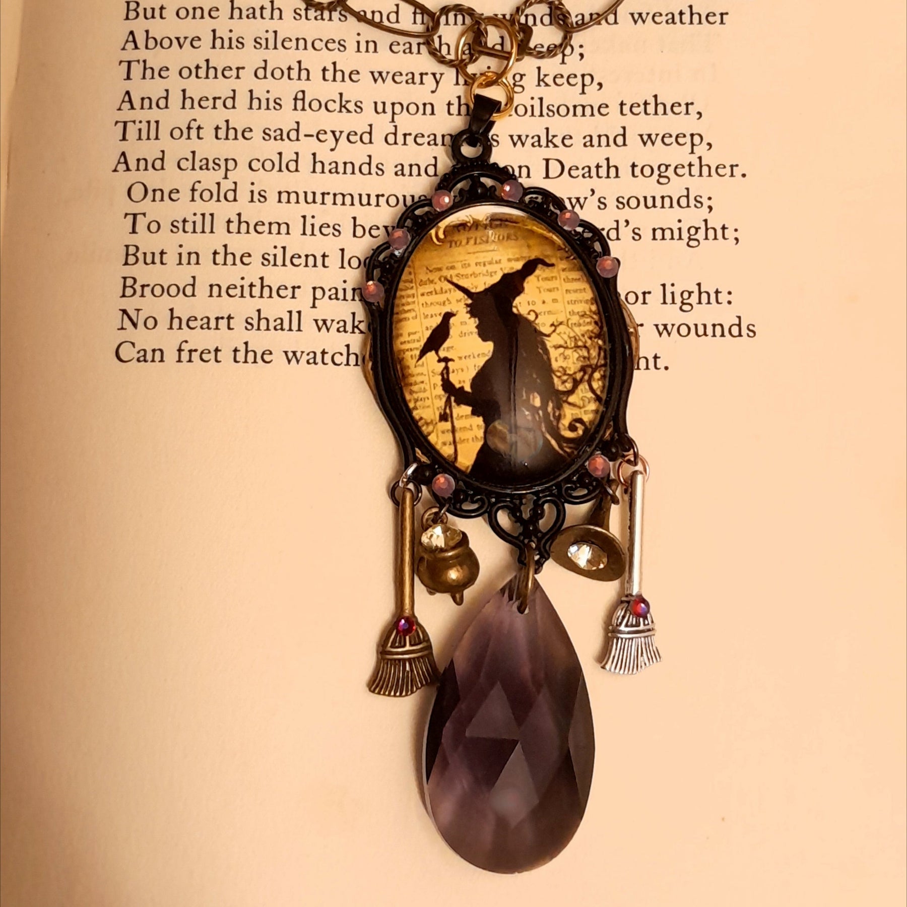 Witchy necklace featuring ravens, a witch hat, cauldron, broom charms, and sparkling Swarovski crystals in purple tones, Victorian style and vintage style magical fantasy jewelry by Rachel Flam Design