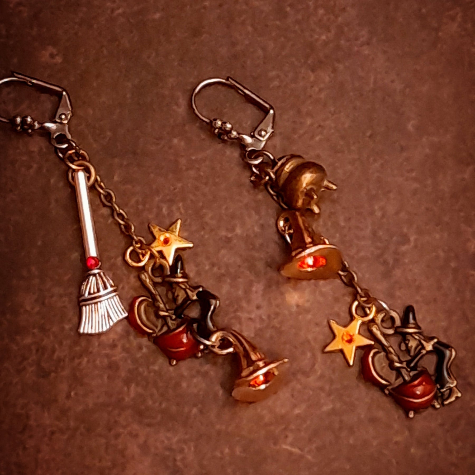 Handmade witchy dangle earrings with Fire Opal and red Swarovski crystals, swinging chains, broom details, and tiny stars, Victorian style and vintage style magical fantasy jewelry by Rachel Flam Design