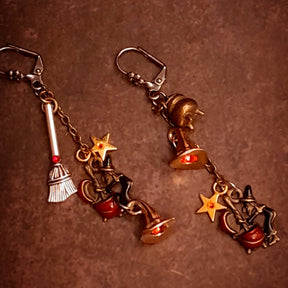 Handmade witchy dangle earrings with Fire Opal and red Swarovski crystals, swinging chains, broom details, and tiny stars, Victorian style and vintage style magical fantasy jewelry by Rachel Flam Design