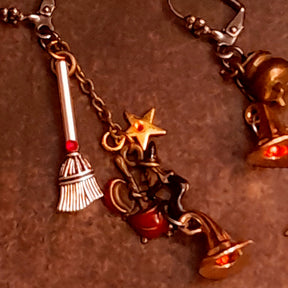 Hand-assembled witch earrings with broom charms, star details, witch and cauldron scenes, Fire Opal crystals, and red Swarovski sparkle, Victorian style and vintage style magical fantasy jewelry by Rachel Flam Design