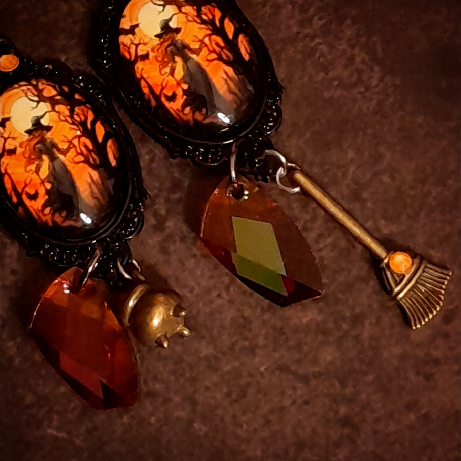 Detailed handmade Halloween witchy earrings with sparkling crystal drops, cauldron and broom charms, moonlit scenes, and fairies hidden on the back, Victorian style and vintage style magical fantasy jewelry by Rachel Flam Design