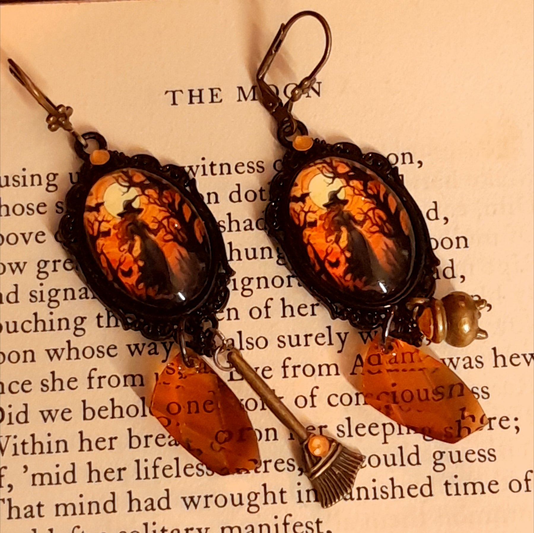Witchy dangle Halloween earrings featuring moonlit scenes, faceted crystal drops, cauldron and broom charms, and secret fairy details on the reverse, Victorian style and vintage style fantasy jewelry by Rachel Flam Design