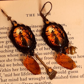 Witchy dangle Halloween earrings featuring moonlit scenes, faceted crystal drops, cauldron and broom charms, and secret fairy details on the reverse, Victorian style and vintage style fantasy jewelry by Rachel Flam Design