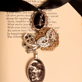 Close up of witchy masquerade Halloween necklace showing ornate filigree mask, Victorian style vintage style Swarovski crystal jewelry