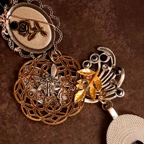 Witchy masquerade Halloween necklace showing layered charms and sculptural details, Victorian style vintage style gothic fantasy necklace
