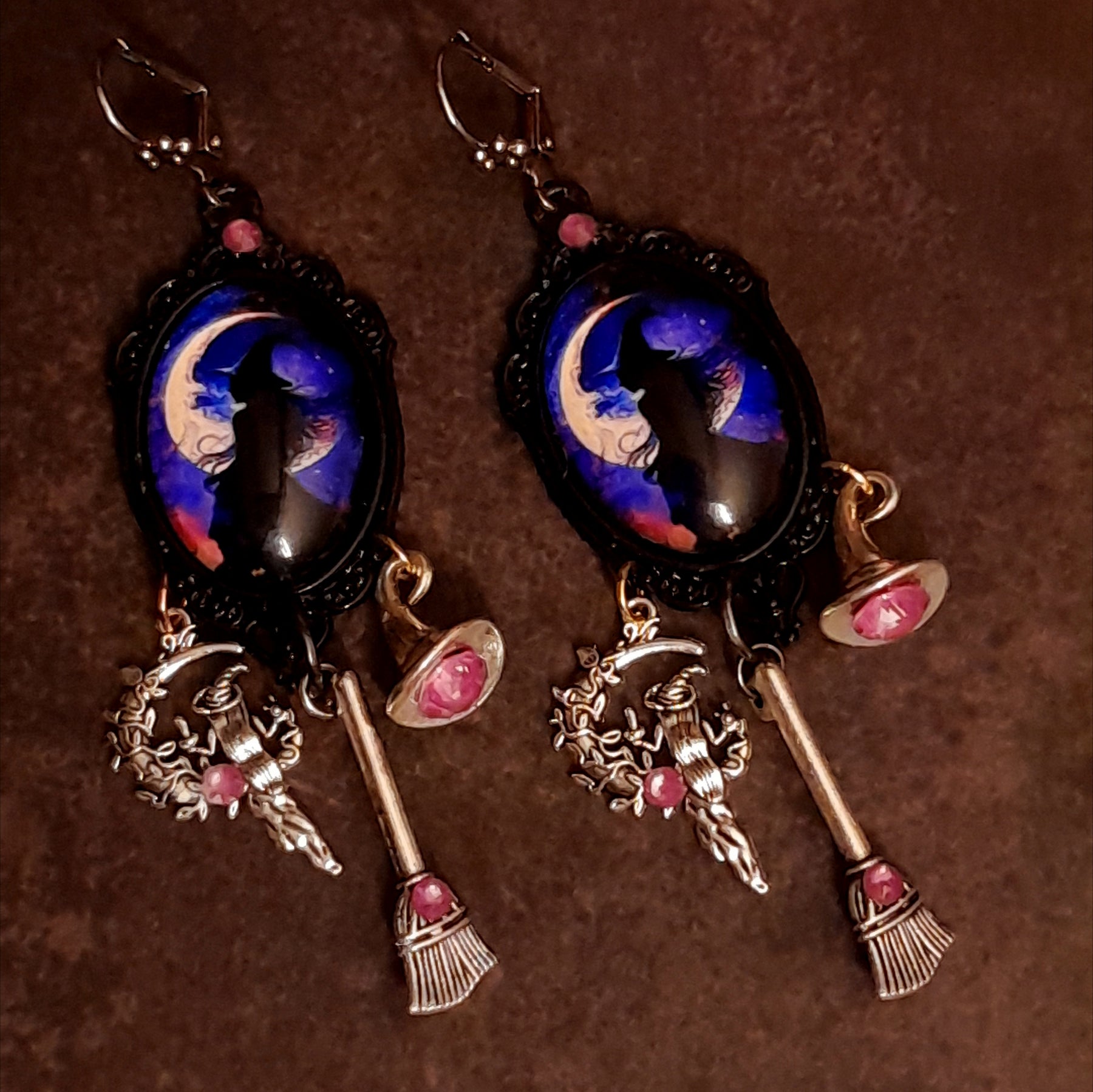 Handmade witchy moon earrings with purple and blue crescent moon scenes, pink Swarovski crystals, witch hat and broom dangles, Victorian style and vintage style magical fantasy jewelry by Rachel Flam Design
