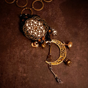 Magical fantasy crescent moon necklace decorated with witchy charms, broomsticks, raven details, potion vessels, dragonfly, and Swarovski crystals, Victorian style and vintage style jewelry by Rachel Flam Design